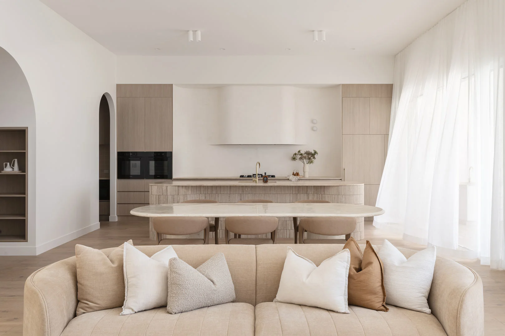 Property-Styling-Neutral-Kitchen-Living-Room-Brass-Kitchen-Mixer-Travertine-Tiles-Sheer-Curtains