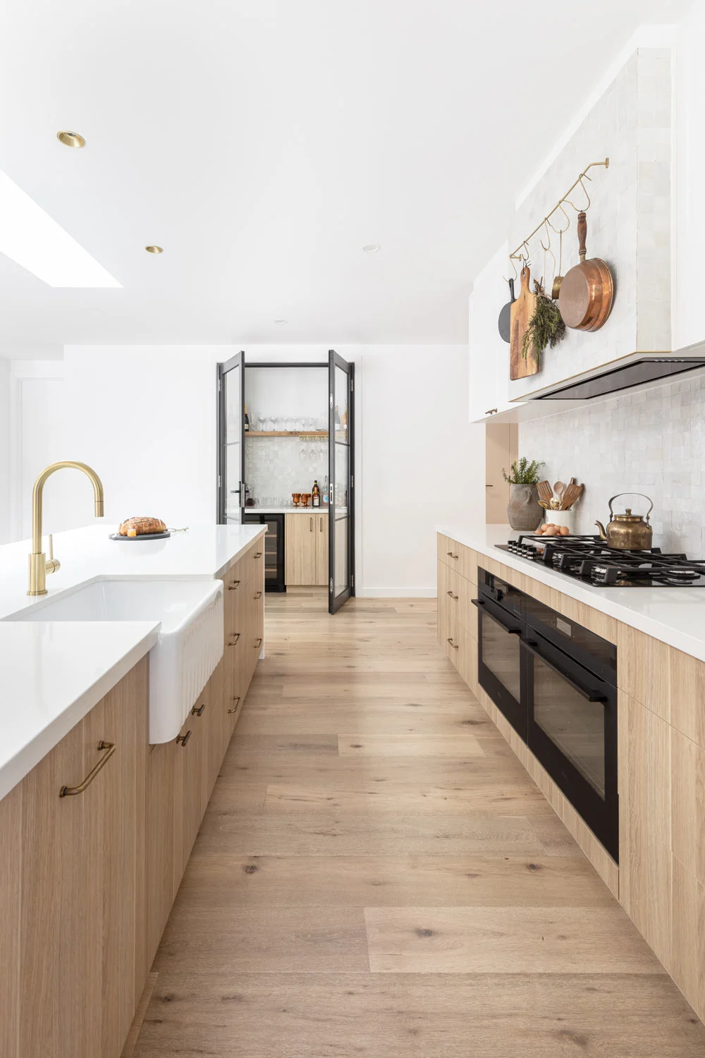 Wood-Interiors-Kitchen-Cabinetry-Flooring-Modern-Farmhouse-Style-White-Tiles-Farmhouse-Sink