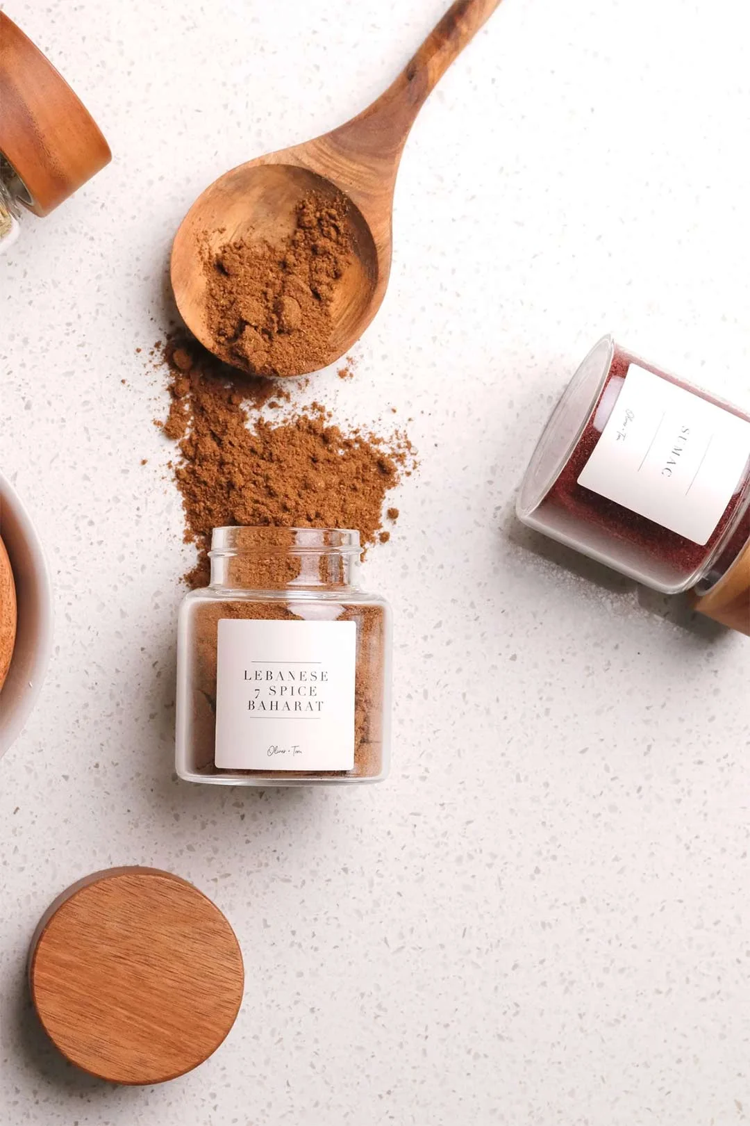 Labelled spice jars in a pull out rack is one of the best kitchen cupboard storage hacks