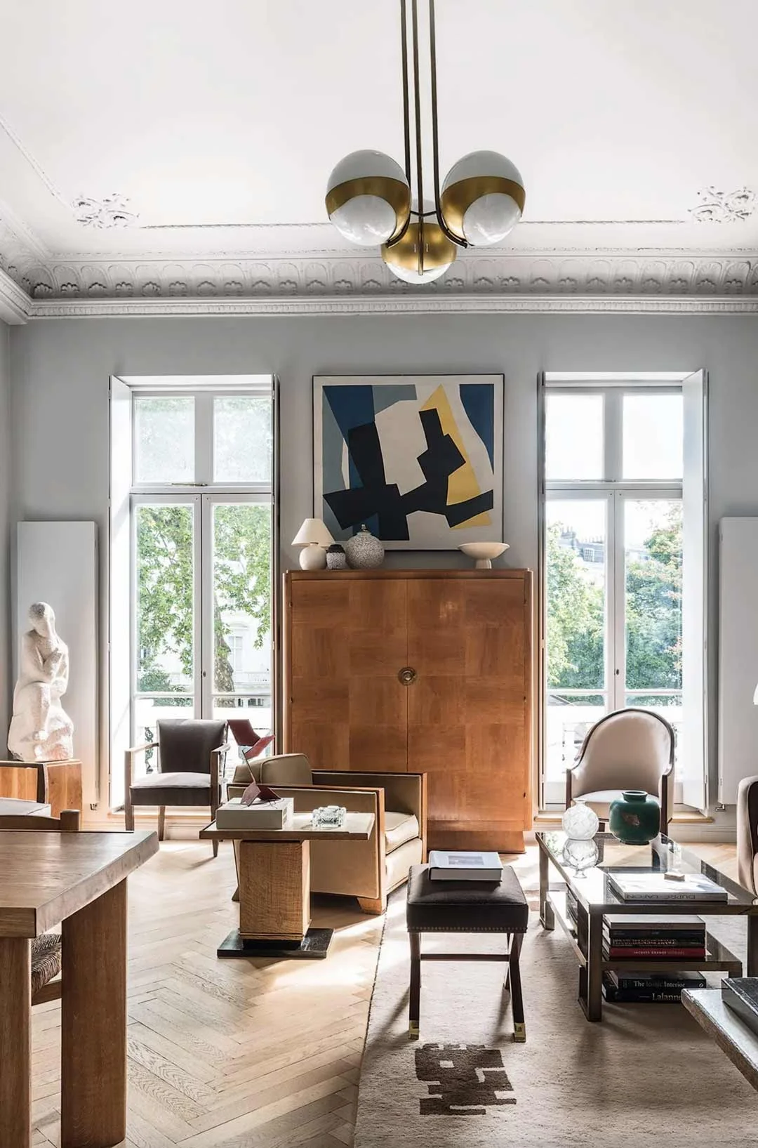 A hipstoric home with a vintage chandelir and modern artwork