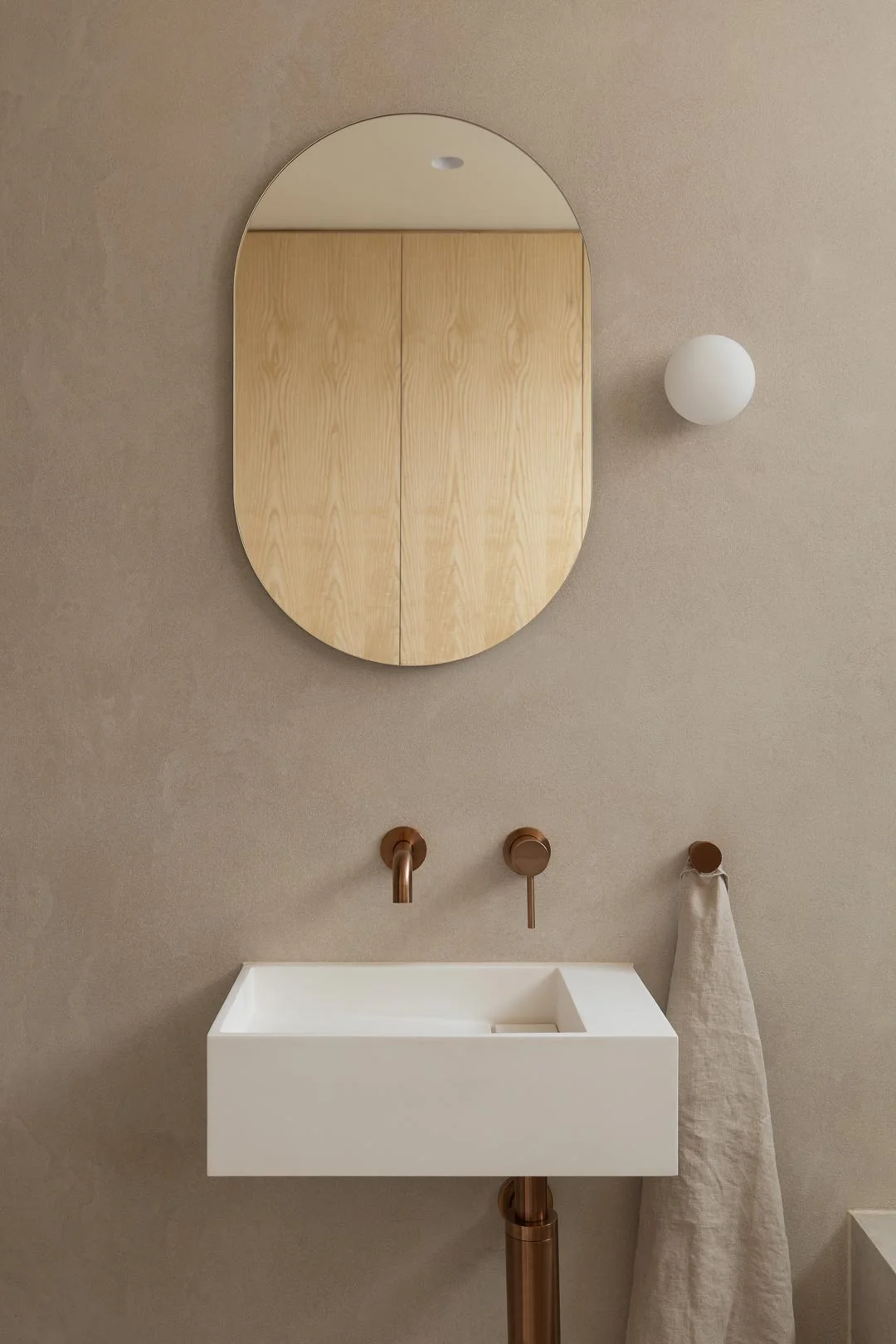 Brushed-copper-tapware-with-Wall-mounted-basin-small-neutral-bathroom
