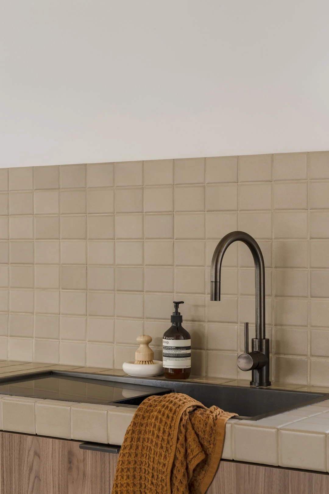 How-to-clean-tile-grout-in-kitchen-beige-square-tiles-with-brushed-gunmetal-tap
