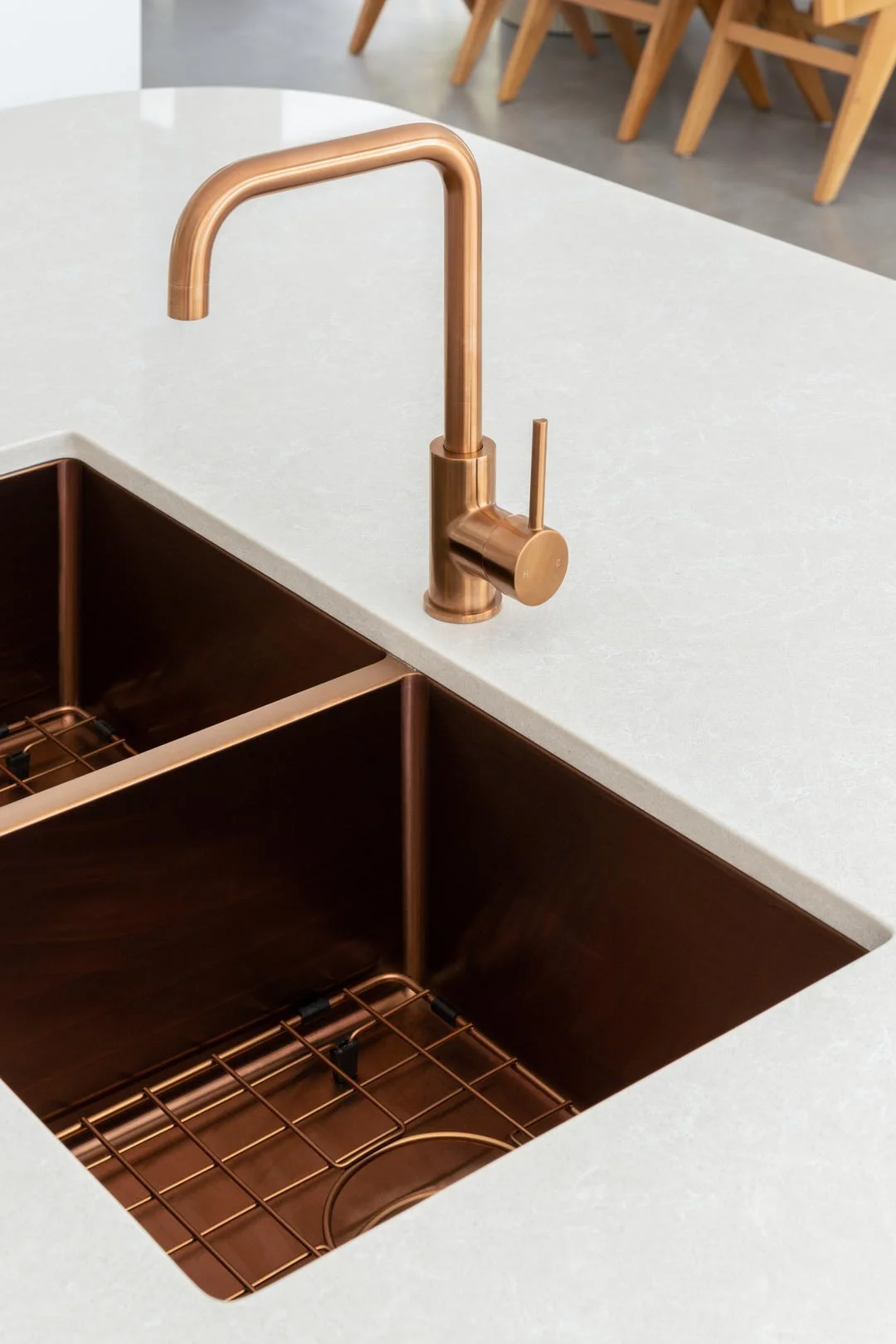 Brushed copper double undermount sink paired with a matching mixer