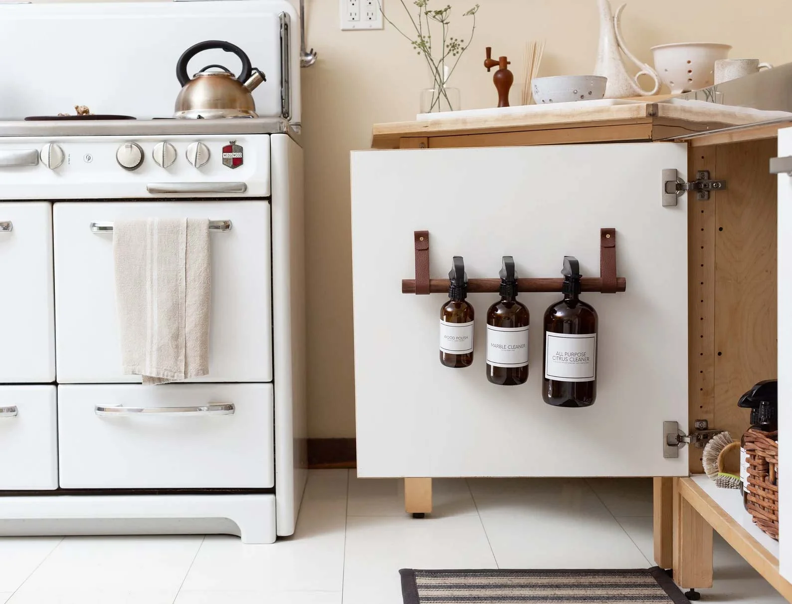 Under kitchen sink storage ideas easy DIY tension rod for spray bottles