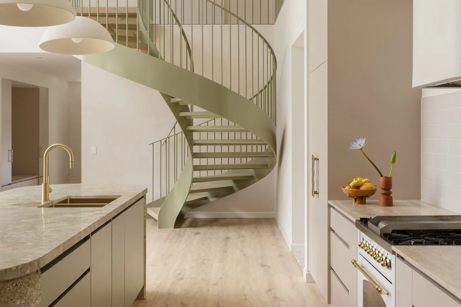 green-spiral-staircase-in-natural-stone-kitchen