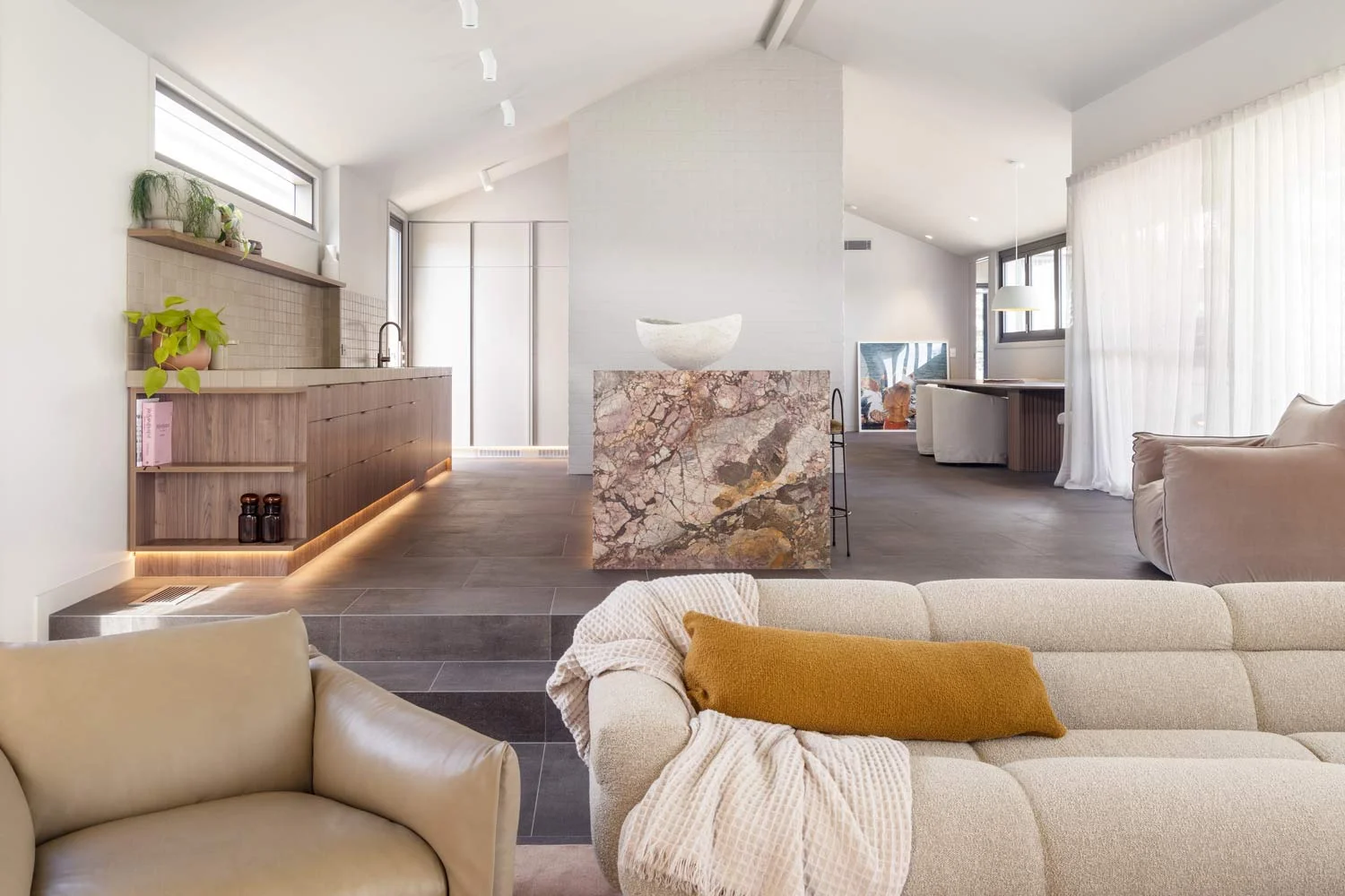 open-plan-living-kitchen-marble-island-bench-charcoal-floor-tile