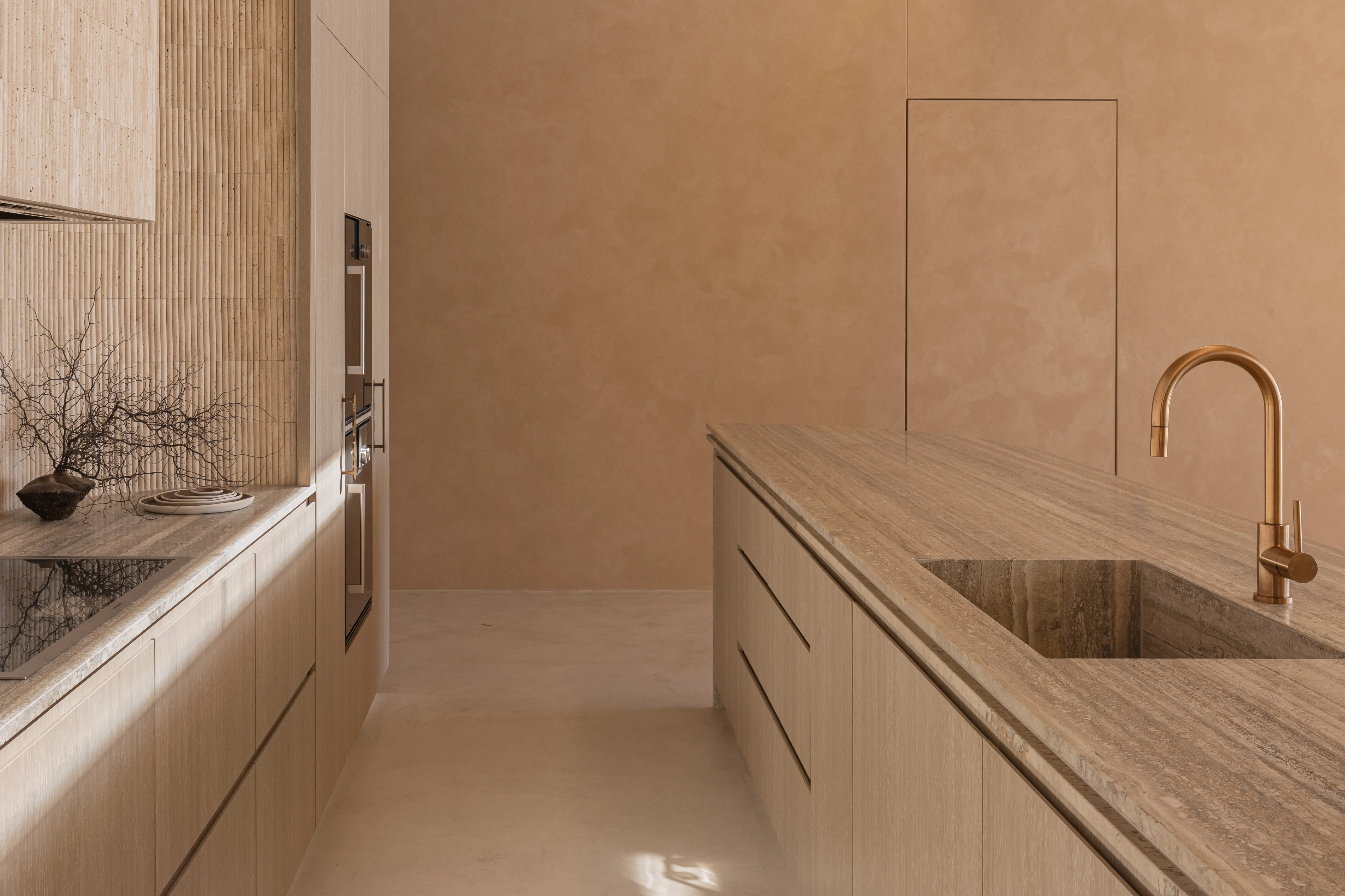 Luxury-Modern-Kitchen-Design-Trends-Neutral-Tones-Sustainable-Materirals-Fluted-Travertine-Marble-Countertops-Brushed-Copper-Kitchen-Mixer
