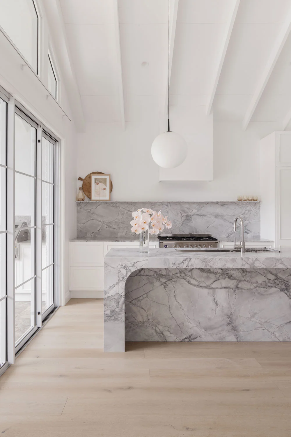 Luxury-Modern-Kitchen-Design-Open-Plan-Marble-Island-Bench-Splashback-Brushed-Nickel-Tapware-Fixtures-Oak-Timber-Flooring-Floor-Ceiling-Windows