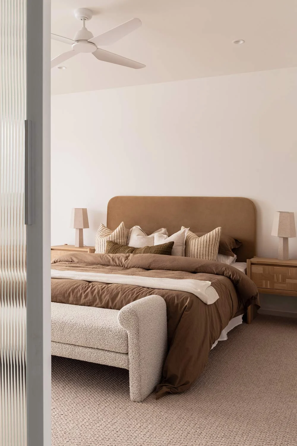 Happy-Haus-Modern-Interior-Design-Fluted-Glass-Door-Brown-Earth-Tone-Bedding-Cream-Carpet