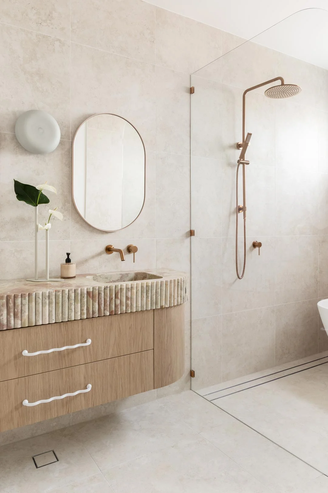 pinky onyx vanity with scallop edges and brushed copper tapware