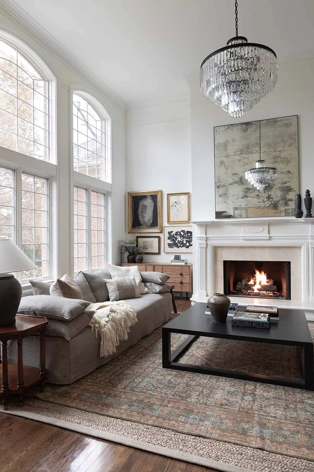 A vintage inspired living room with a layered rug