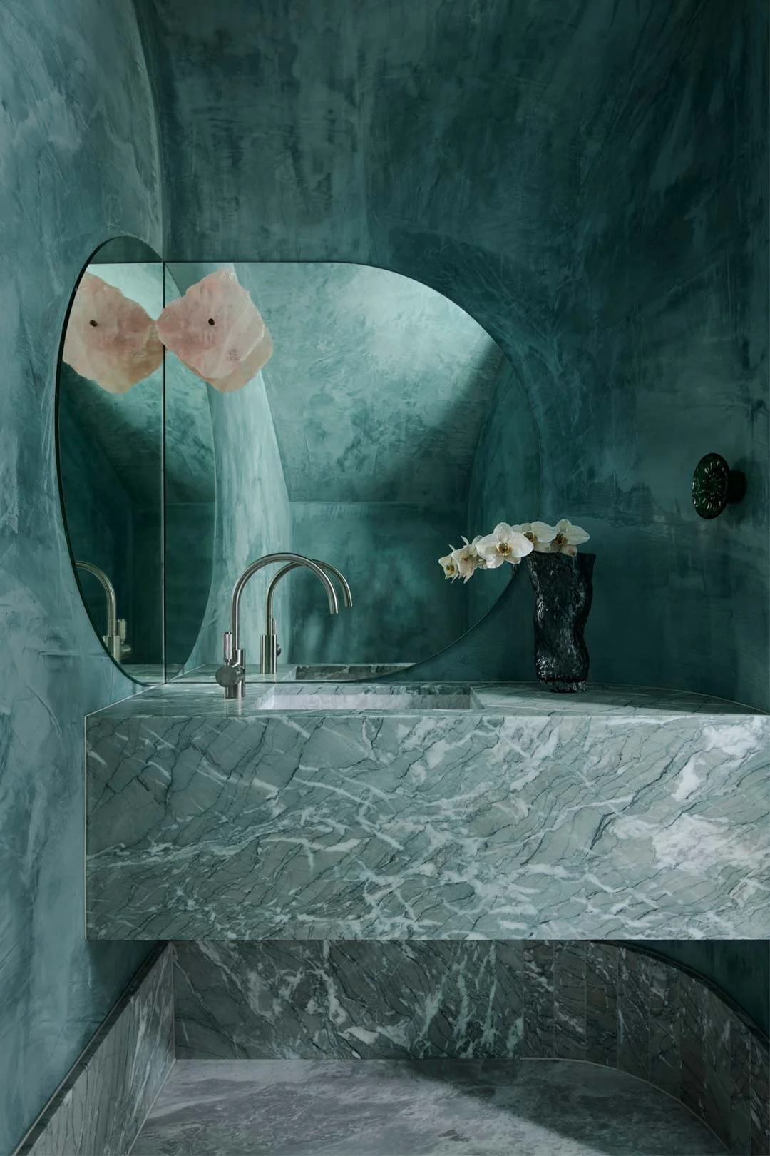 An opulant bathroom design enhanced with a monochromatic colour shceme in green