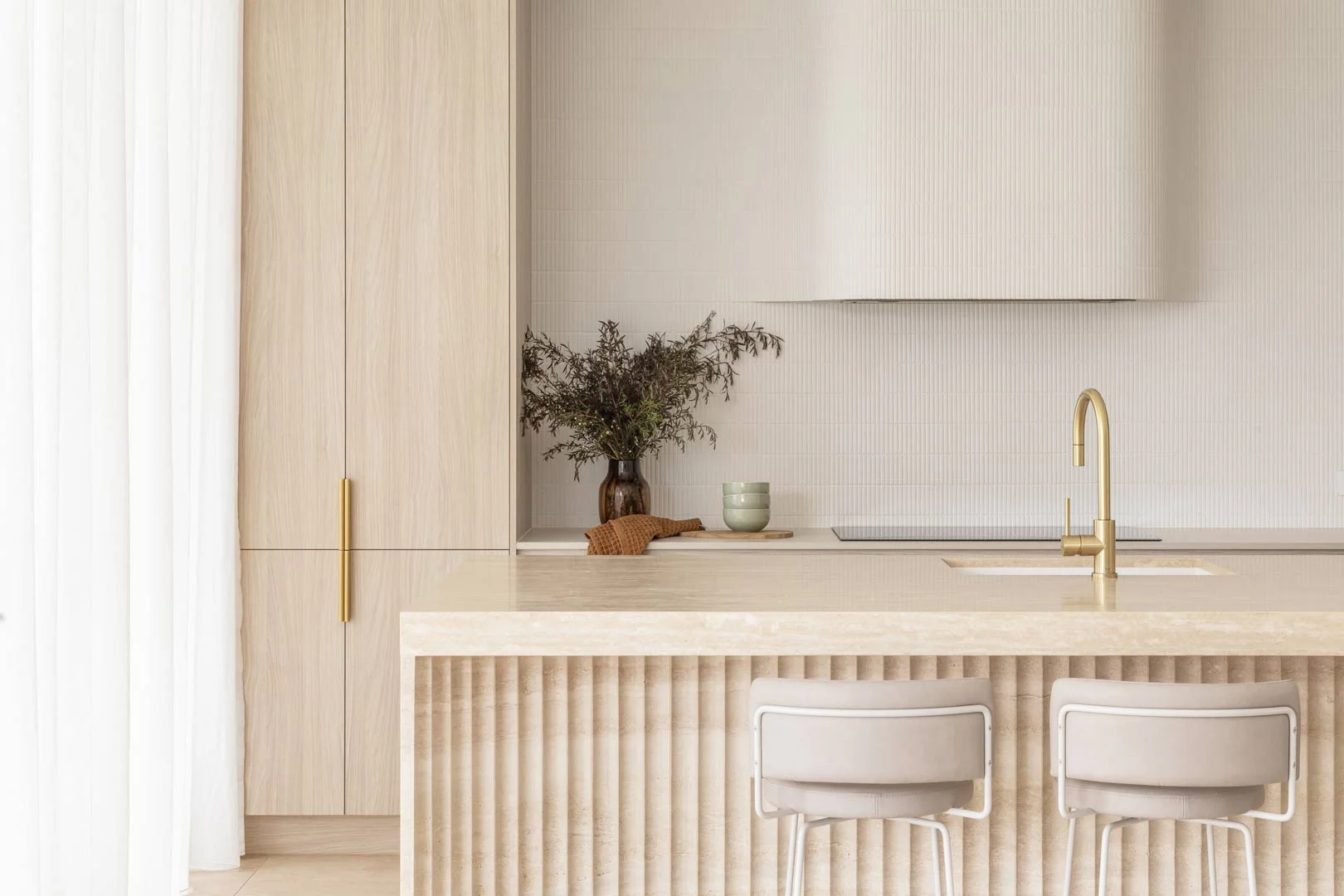Brass-Tapware-Kitchen-Mixer-Kit-Kat-Tiles-Oak-Cabinetry-Travertine-Benchtop
