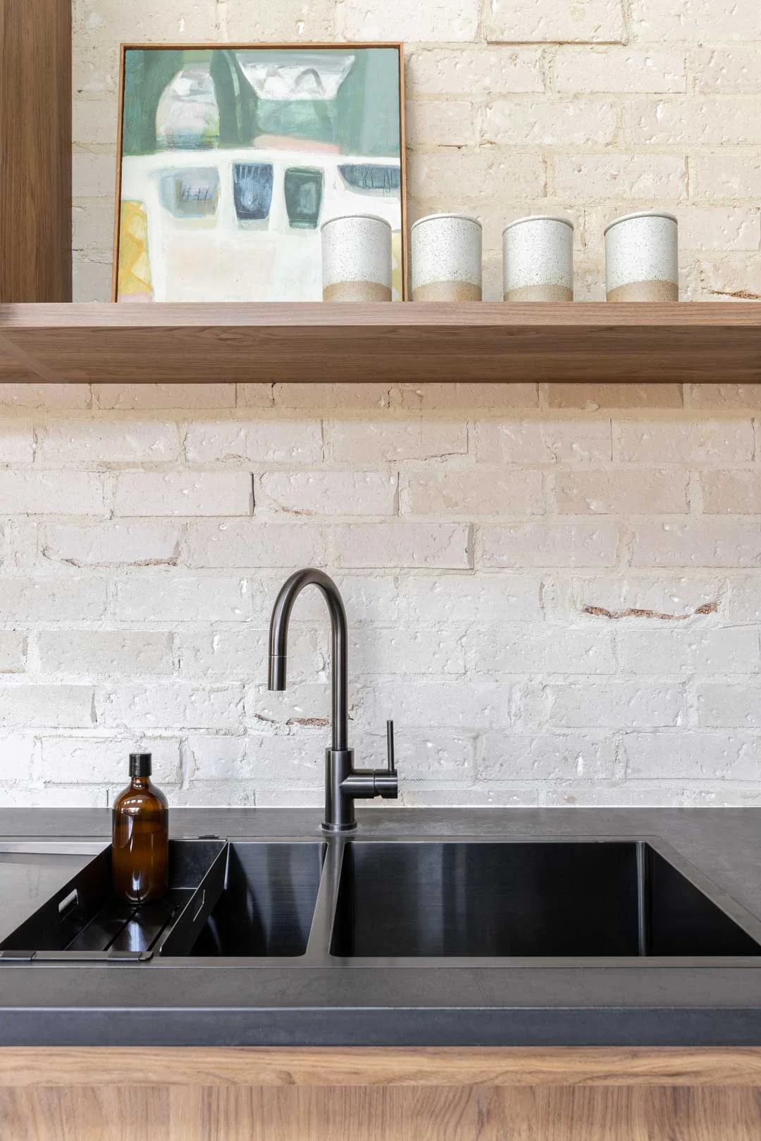 A neat and organised kitchen sink area with kitchen sink accessories