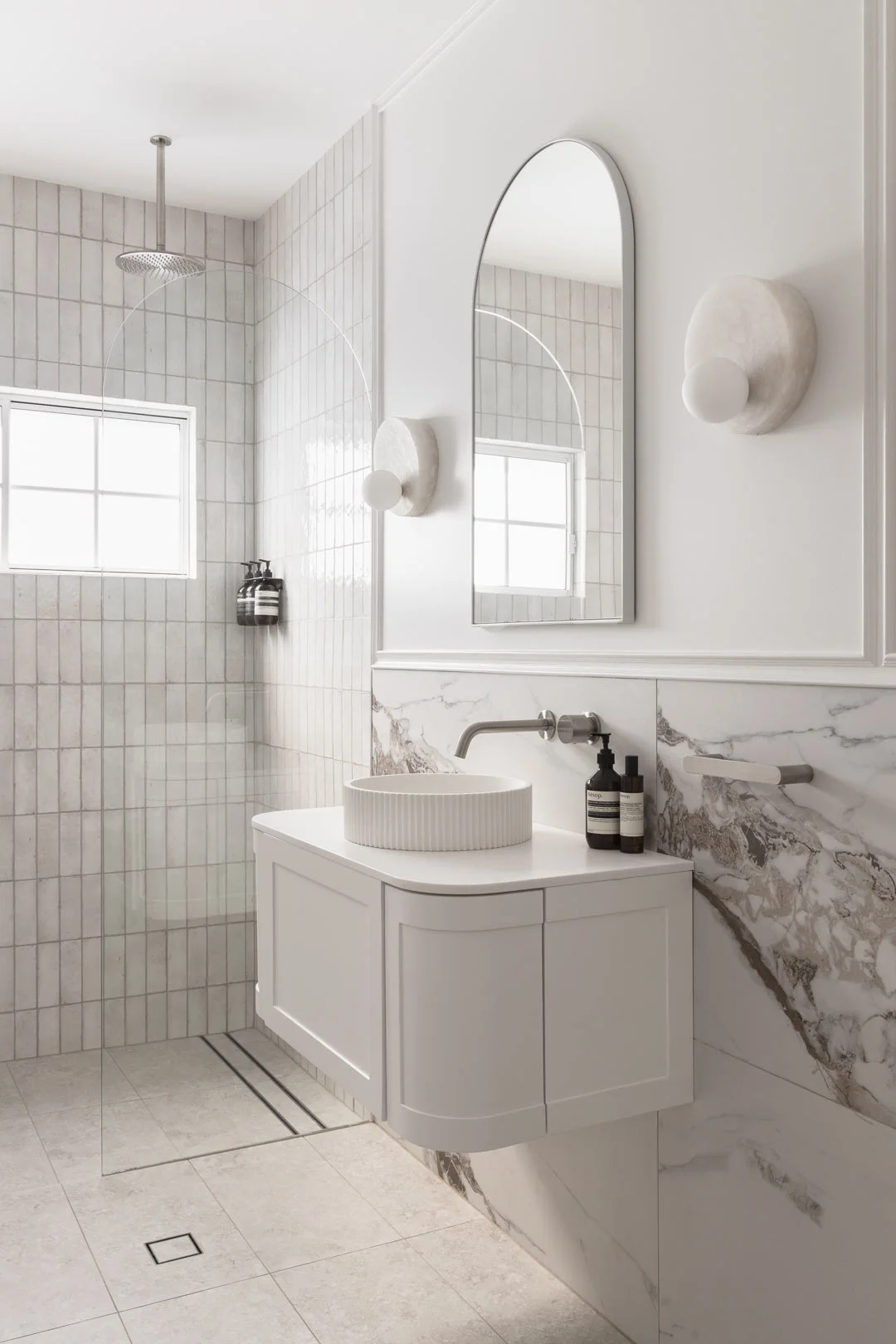 brushed-nickel-curved-vanity-marble-tile-modern-bathroom