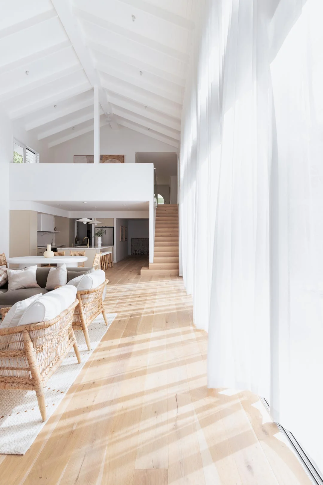 A-light-filled-kitchen-and-living-room-with-a-pitched-roof-and-floor-to-ceiling-sheers-by-Deb-and-Andy
