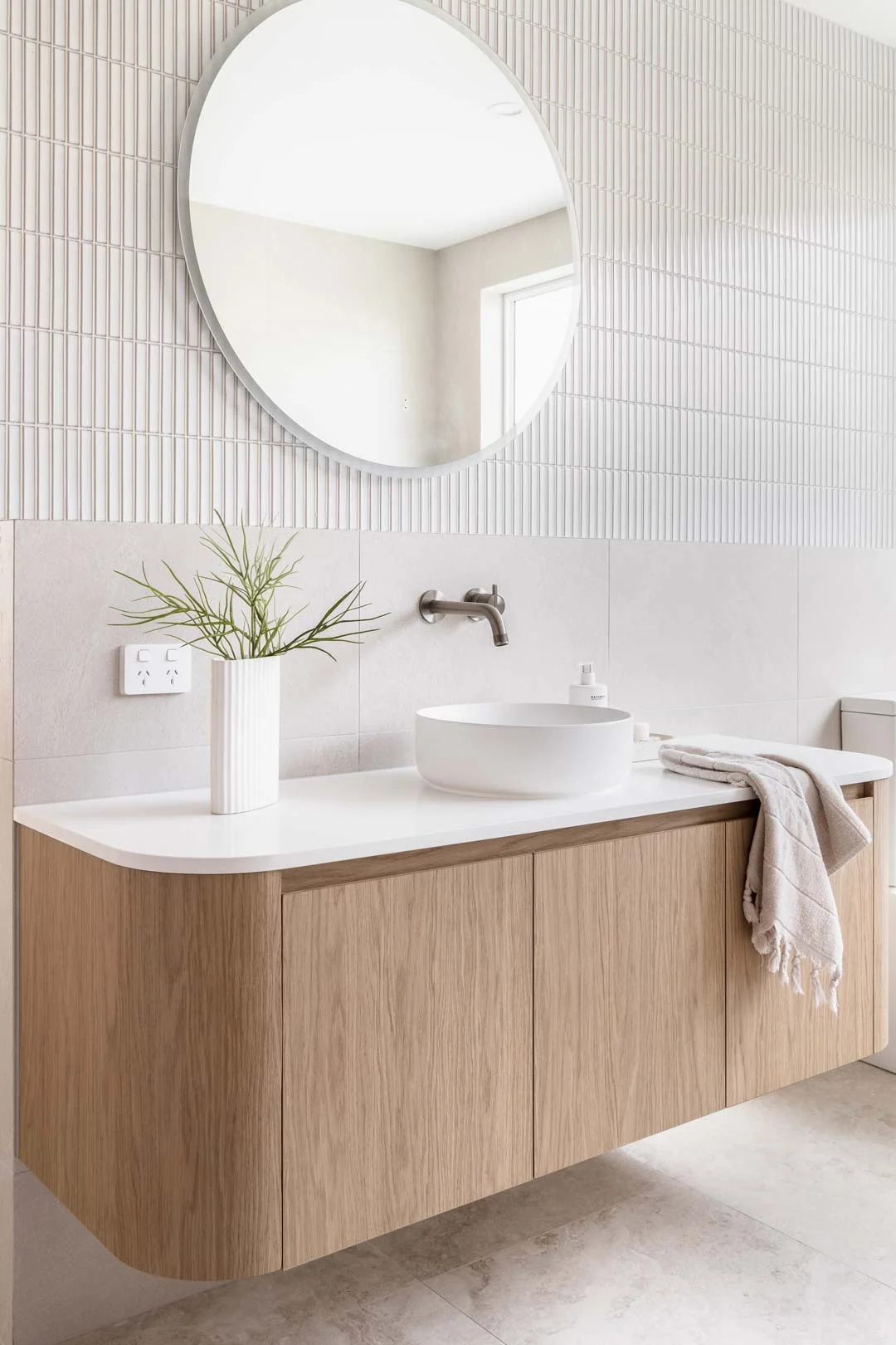 brushed-nickel-ribbed-tapware-curved-wood-vanity-minimal-bathroom
