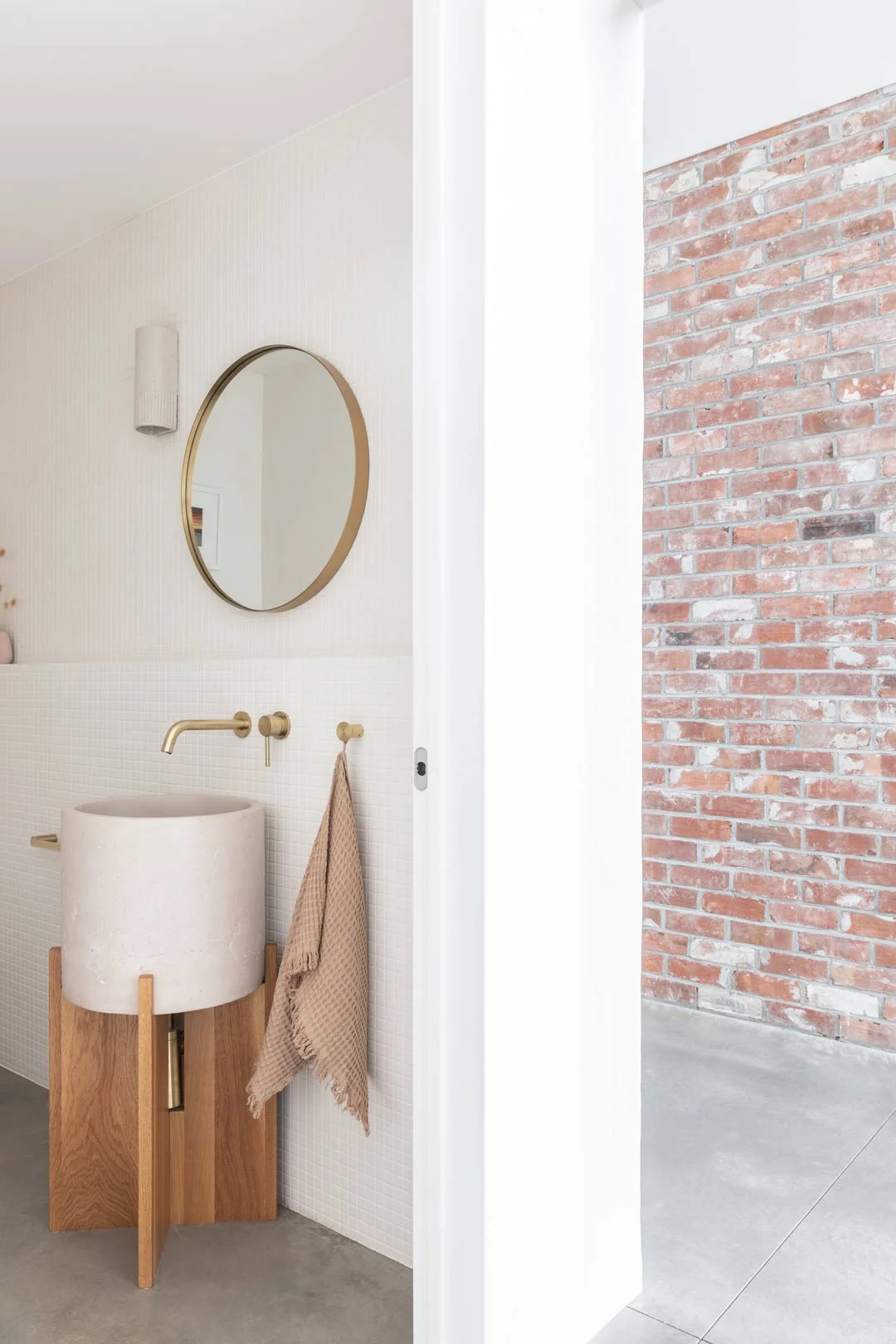 modern-farmhouse-bathroom-concrete-basin-and-red-brick-wall