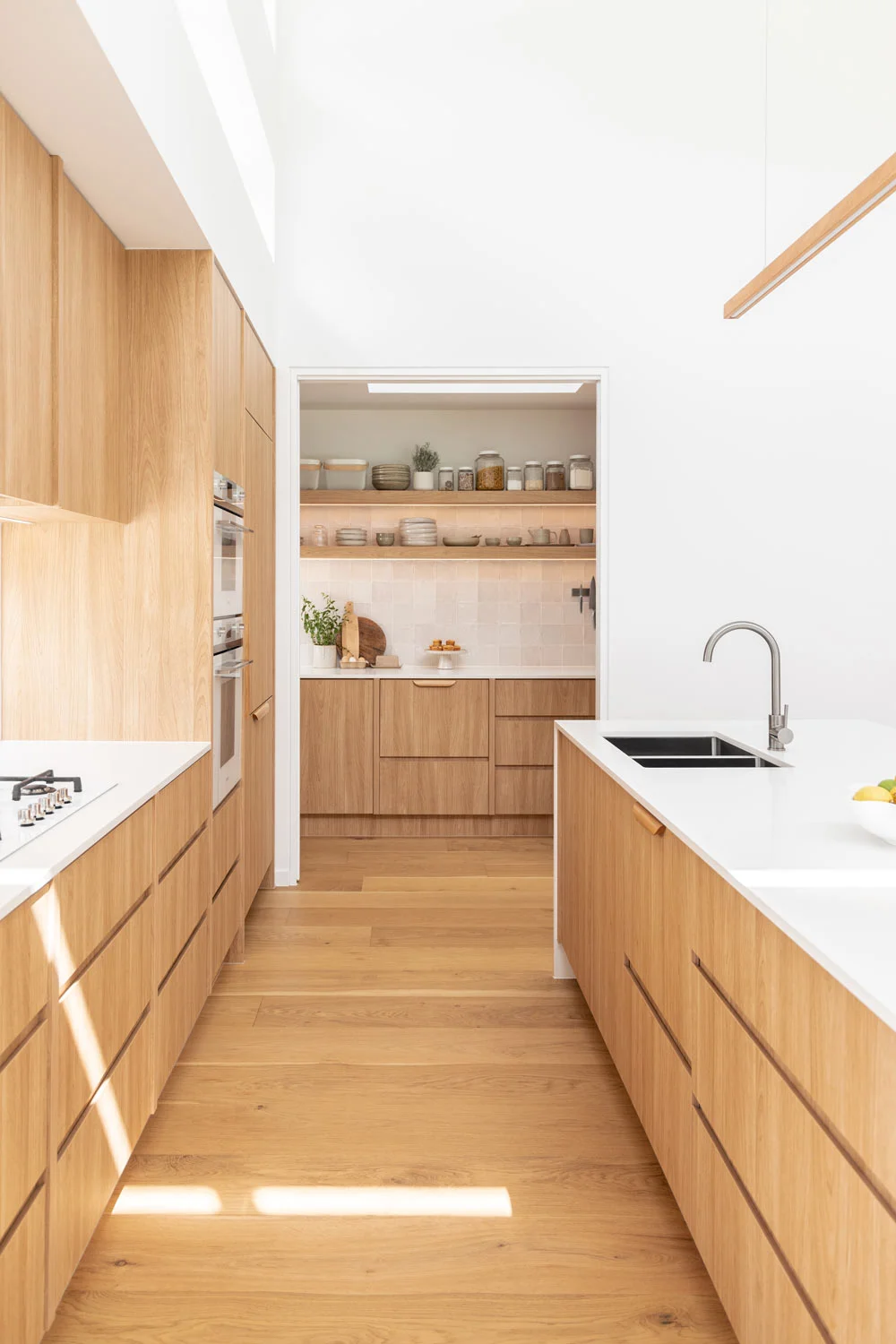Wood-Interiors-Scandinavian-Kitchen-Butlers-Pantry-Oak-Timber-Cabinetry-Flooring-White-Kitchen-Benches-Brushed-Nickel-Stainless-Steel-Kitchen-Tap-Sink
