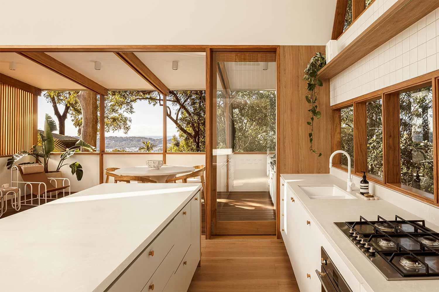 Organic-Modern-Interior-Design-Open-Plan-Kitchen-White-Kitchen-Tap-White-Benchtops-Timber-Floorboards