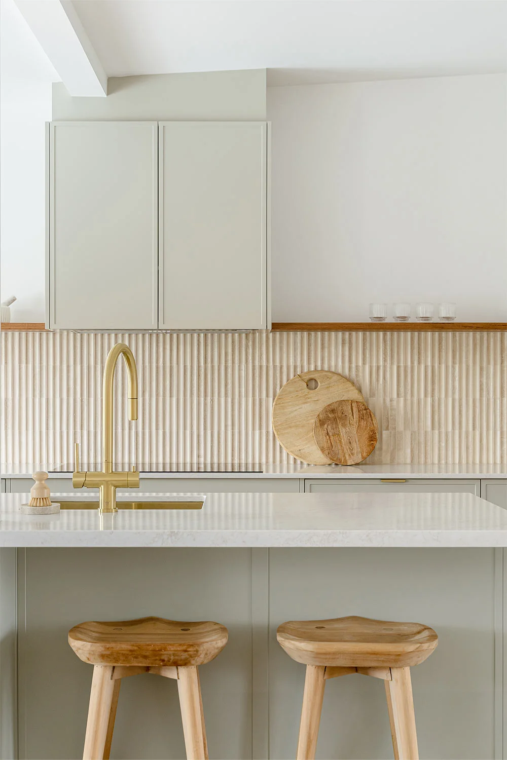 Shaker-Style-Kitchen-Soft-Green-Cabinetry-Fluted-Travertine-Splashback-Tiles-Brushed-Brass-Kitchen-Tap