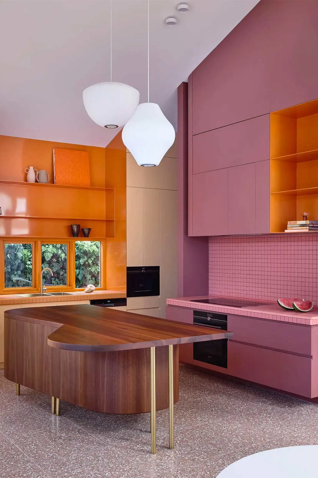 A bright and colourful mid century modern kitchen nods to Barbiecore and a nostalgic interior