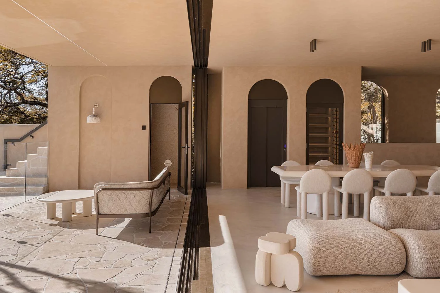 Organic-Modern-Interior-Design-Open-Plan-Living-Indoor-Outdoor-Limewash-Walls-Arch-Doorways-Crazy-Pave-Flooring-Boucle-Couch