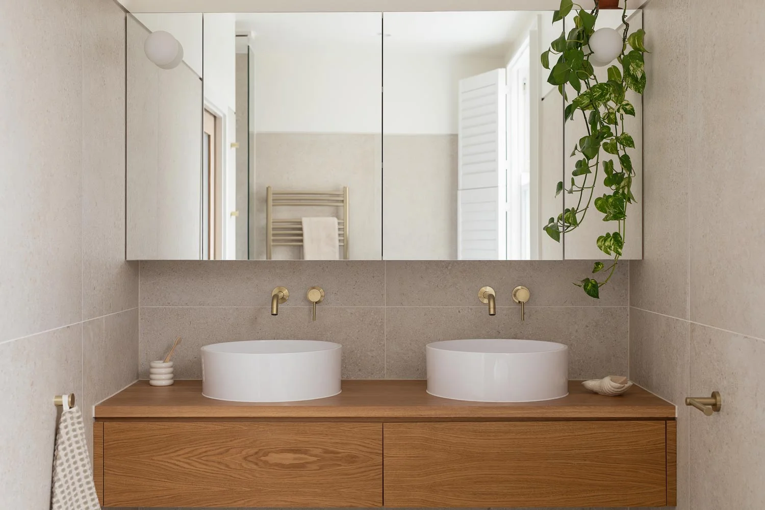 brushed-brass-bathroom-tapware-over-double-vanity
