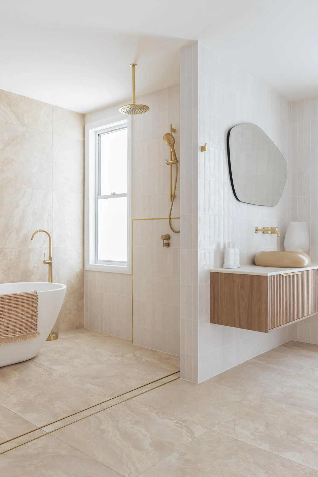 A-warm-and-inviting-modern-coastal-bathroom-with-brushed-brass-tapware